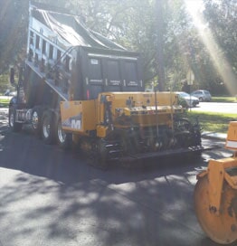 Operating vehicles performing residential asphalt resurfacing in Tampa, FL